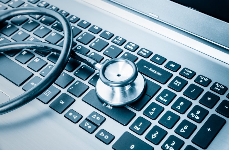 Stethoscope over a computer keyboard toned in blue