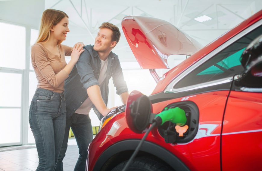 A couple charging an EV